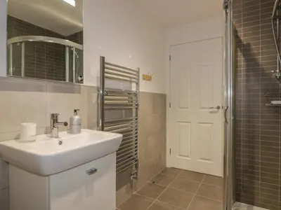 a bathroom with a sink and a shower at Stores & Supplies in Bodmin