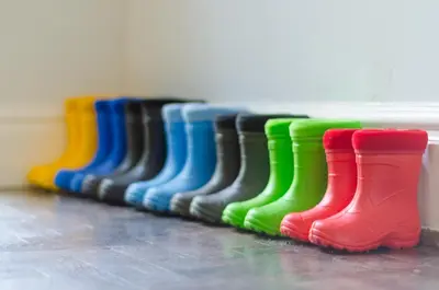 a row of colorful rain boots lined up in a row at Luxury Victorian school with views of Harbour in Fowey