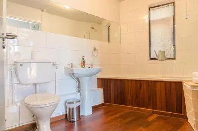 a bathroom with a toilet and a sink and a tub at Charming Summerhouse Annexe in lush gardens in Fowey in Fowey