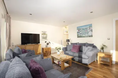 a living room with couches and a flat screen tv at Lodge 40 - Resort & Spa & Hot Tub & Free Wi-Fi in Saint Columb Major