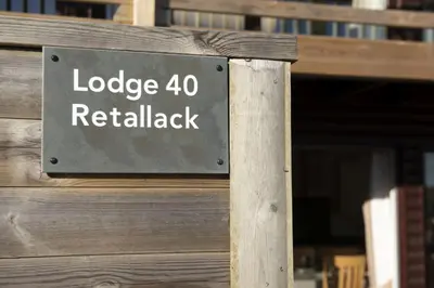 a sign that reads lodge retrievalack on a building at Lodge 40 - Resort & Spa & Hot Tub & Free Wi-Fi in Saint Columb Major