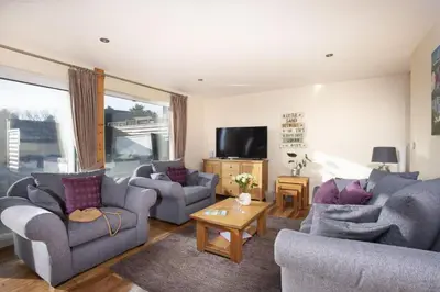 a living room with two couches and a tv at Lodge 40 - Resort & Spa & Hot Tub & Free Wi-Fi in Saint Columb Major