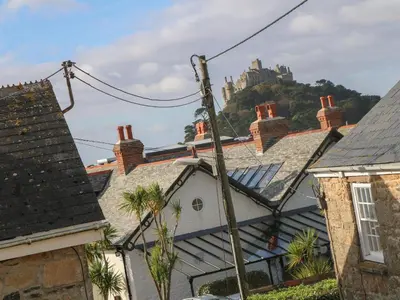 a view of a castle on a hill with houses at Nana's House in Marazion