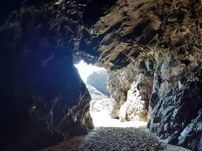 a cave with a light at the end of it at 67 Newquay Getaway in Porth