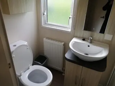 a small bathroom with a toilet and a sink at 67 Newquay Getaway in Porth