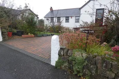 a garden with a brick path in front of a house at Ferney Croft in Saint Erth