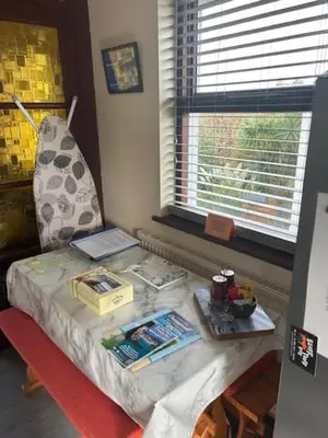 a room with a table with a bed and a window at Ferney Croft in Saint Erth