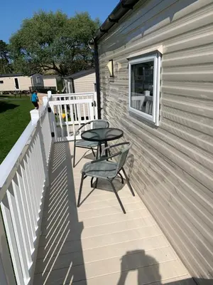 a patio with two chairs and a table on a building at Newquay Bay in Newquay
