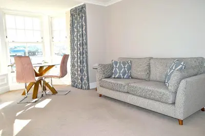a living room with a couch and a table at Avala in Perranporth