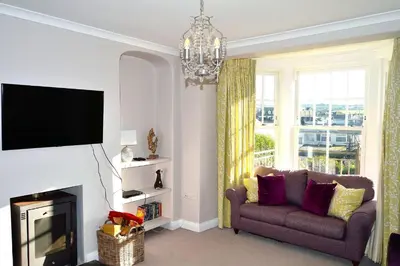 a living room with a couch and a fireplace at Avala in Perranporth