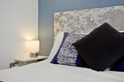 a bedroom with a bed with a pillow on it at Blue Bay, Marazion in Perranuthnoe