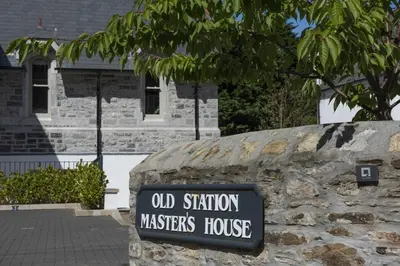 a sign on a stone wall in front of a house at Fowey Penthouse, Fowey in Fowey