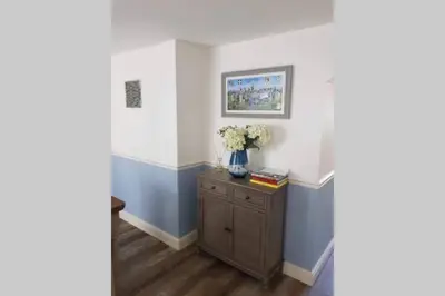 a room with a vase of flowers on a cabinet at Beautiful Cottage in Central St Columb Major in Saint Columb Major