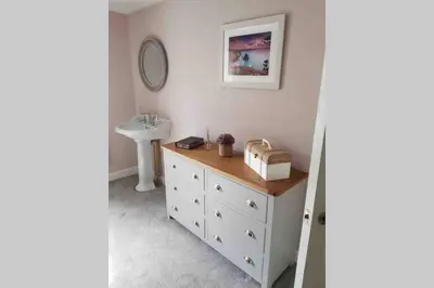 a bathroom with a sink and a white dresser at Beautiful Cottage in Central St Columb Major in Saint Columb Major
