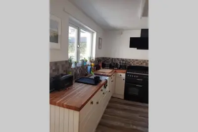 a kitchen with a counter and a stove top oven at Beautiful Cottage in Central St Columb Major in Saint Columb Major