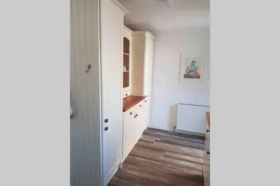 a hallway with white walls and a wooden floor at Beautiful Cottage in Central St Columb Major in Saint Columb Major