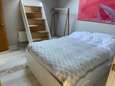 a bedroom with a bed next to a staircase at Beautifully Converted Chapel in Blisland