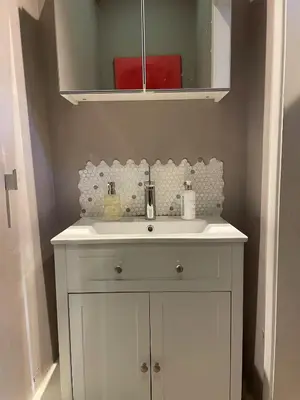 a bathroom with a white sink and a mirror at Beautifully Converted Chapel in Blisland