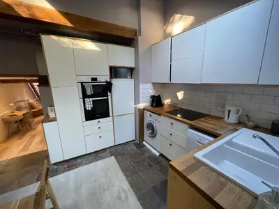 a kitchen with white cabinets and a sink at Beautifully Converted Chapel in Blisland