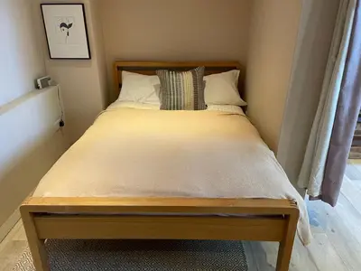 a bed in a small room with a bed sidx sidx sidx at Beautifully Converted Chapel in Blisland