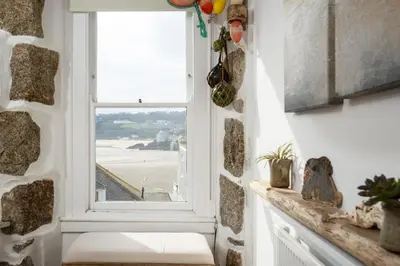 a window in a room with a view of the beach at 3 Victoria House in St Ives