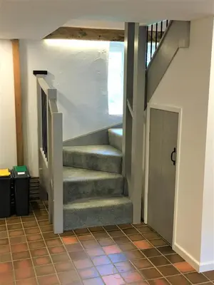 a staircase in a house with a stair case at Jopes Mill and Lodge in Looe