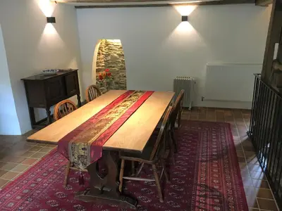 a large wooden table in a room with a table sidx sidx at Jopes Mill and Lodge in Looe