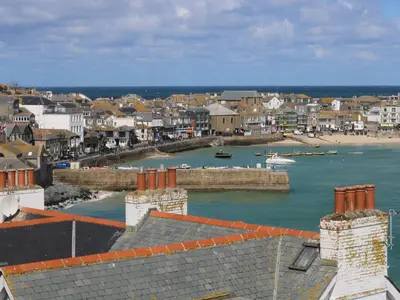 a town with a harbor with boats in the water at The Beach Hut in St Ives