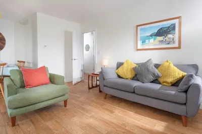 a living room with a couch and two chairs at Endymion in Porthtowan