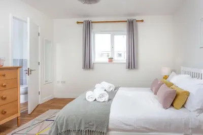 a bedroom with a bed with towels on it at Endymion in Porthtowan