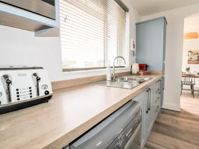 a kitchen with a sink and a stove at Pepperpots in Newquay