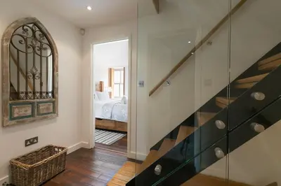 a hallway with a stairway leading to a bedroom at Penhaven in St Ives