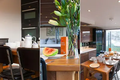 a kitchen with a table with a vase of watermelon at Penhaven in St Ives