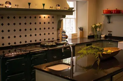 a kitchen with a stove and a counter with a sink at Boconnion Estate Sleeps up to 45 in Bodmin