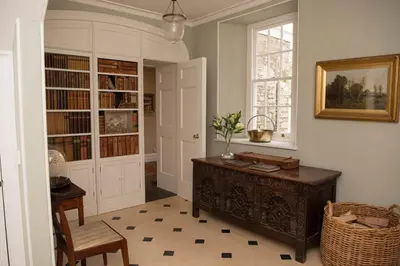 a room with a desk and bookshelves and a window at Boconnion Estate Sleeps up to 45 in Bodmin