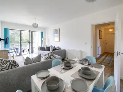 a living room with a couch and a table and chairs at Wheel Water Collections in St Austell