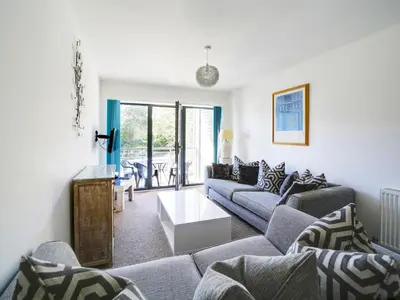 a living room with couches and a table at Wheel Water Collections in St Austell