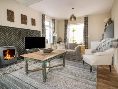 a living room with a tv and a fireplace at Crantock Lodge in Newquay