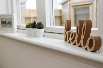 a window sill with a wooden block that reads kill at NEAR BEACHES, contemporary home in village centre in St Merryn
