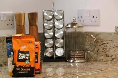 a counter top with a bag of coffee and a blender at NEAR BEACHES, contemporary home in village centre in St Merryn