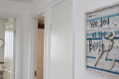 a sign that says see you at the beach next to a mirror at NEAR BEACHES, contemporary home in village centre in St Merryn