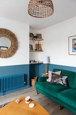 a living room with a green couch and a table at Stunning views over the beautiful Falmouth Harbour in Falmouth