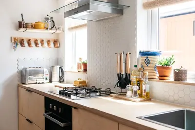 a kitchen with a stove top oven next to a sink at Stunning views over the beautiful Falmouth Harbour in Falmouth