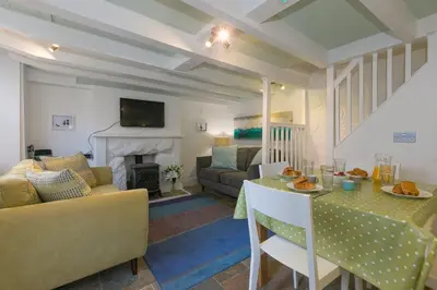 a living room with a couch and a table at Breaking Waves in St Ives