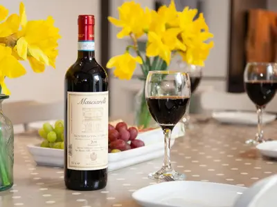 a bottle of wine on a table with a glass of wine at The Sail Loft in St Ives