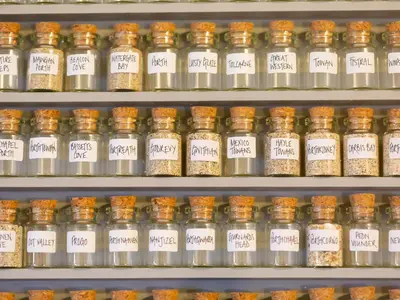 a display of spices on shelves in a store at The Sail Loft in St Ives