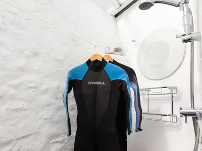 a couple of shirts hanging on a rack at The Sail Loft in St Ives