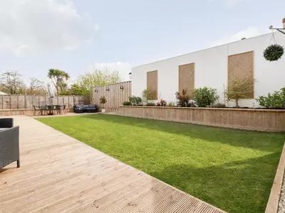 a garden with a lawn and a fence at Penn-An-Vownder in Newquay