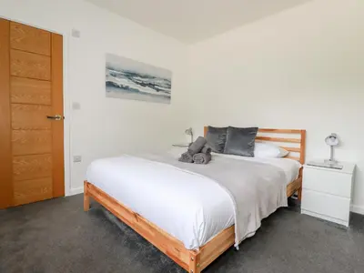 a bedroom with a bed with a teddy bear on it at Penn-An-Vownder in Newquay