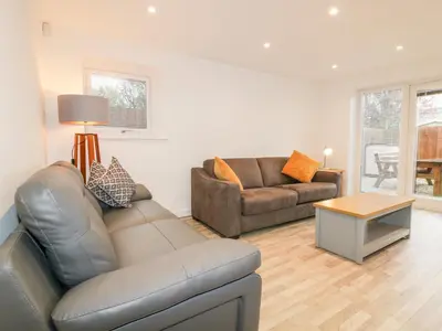 a living room with a couch and a table at Lily Cottage in Camelford